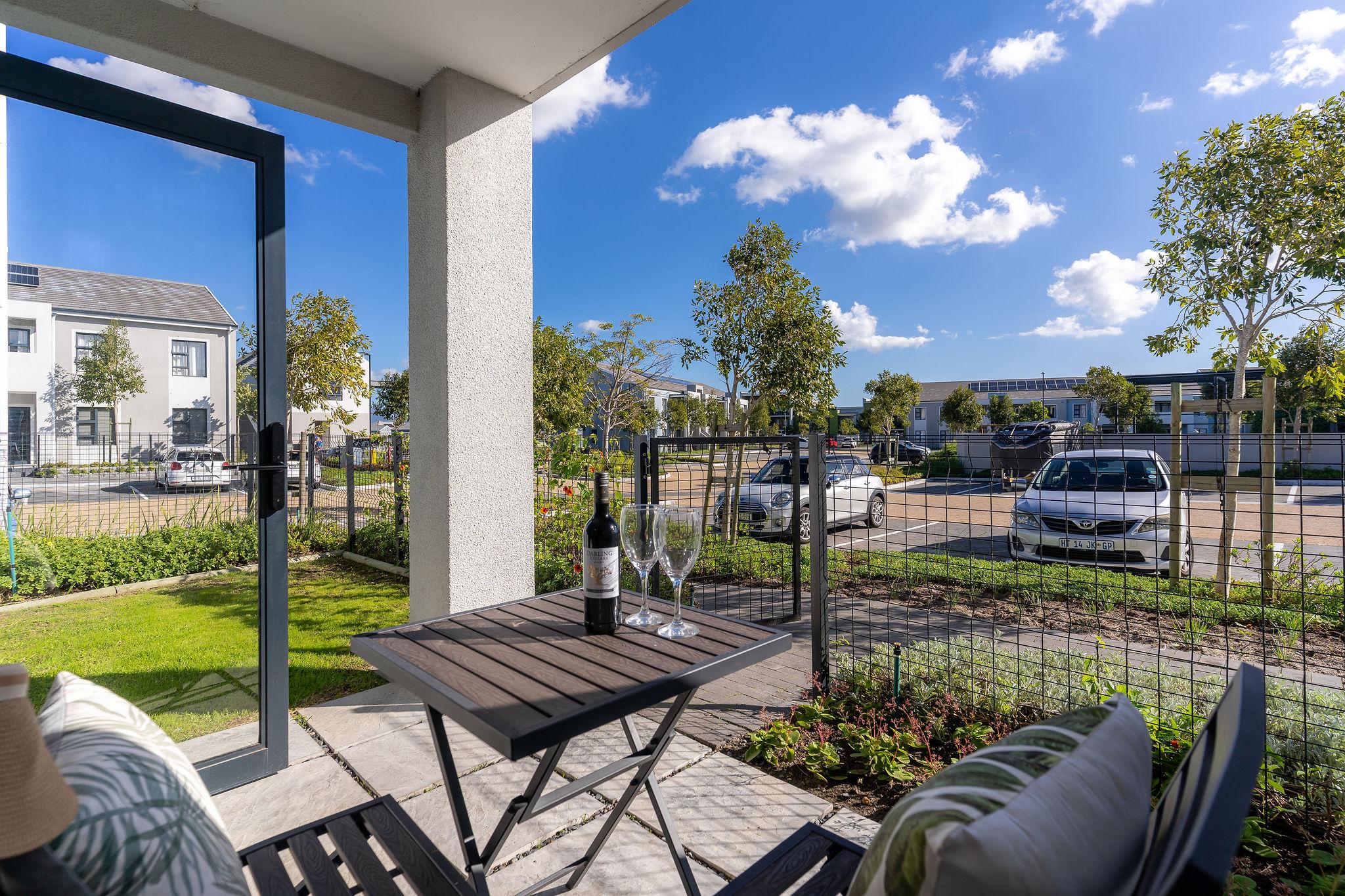 Private patio at Cape Perlant with bistro seating and garden