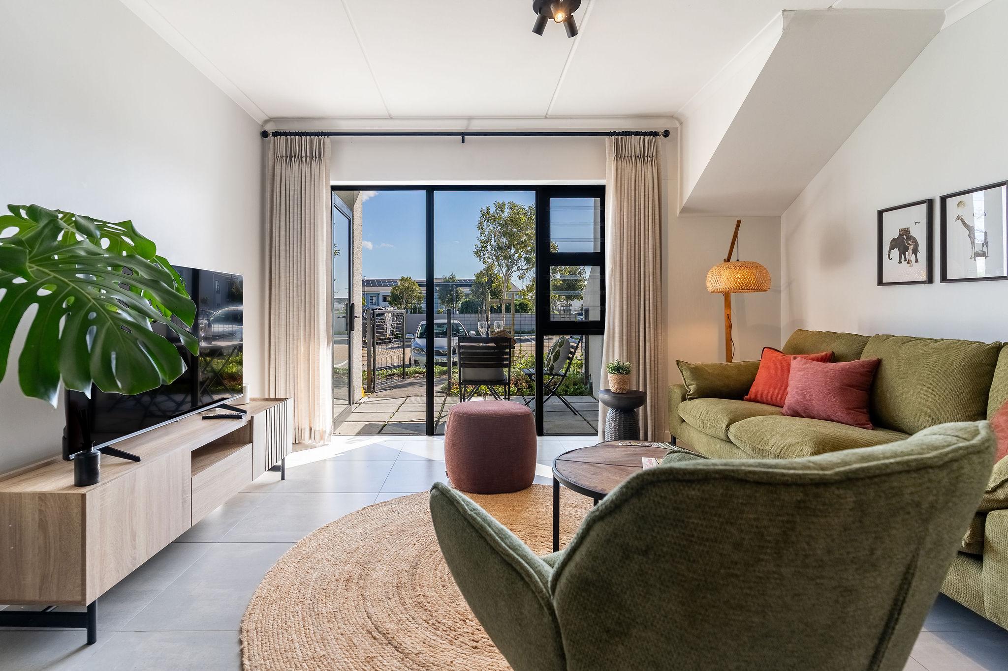 Cape Perlant living room with smart TV and sliding doors onto the private patio