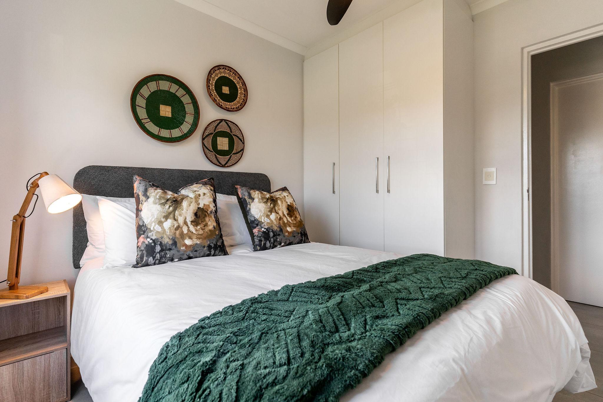 Cape Perlant second bedroom with built-in wardrobes and reading lamp
