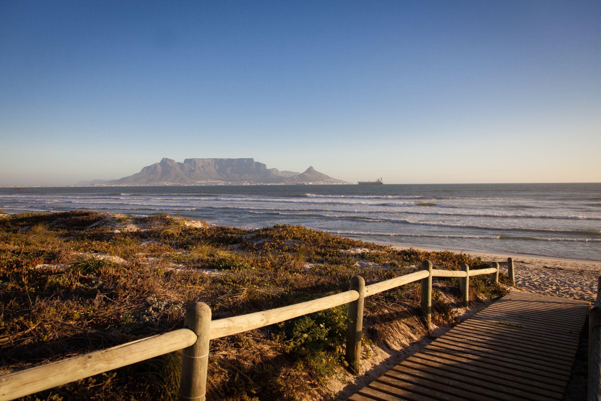 Bloubergstrand Beach boardwalk near Cape Vine, with Table Mountain across the bay at golden hour