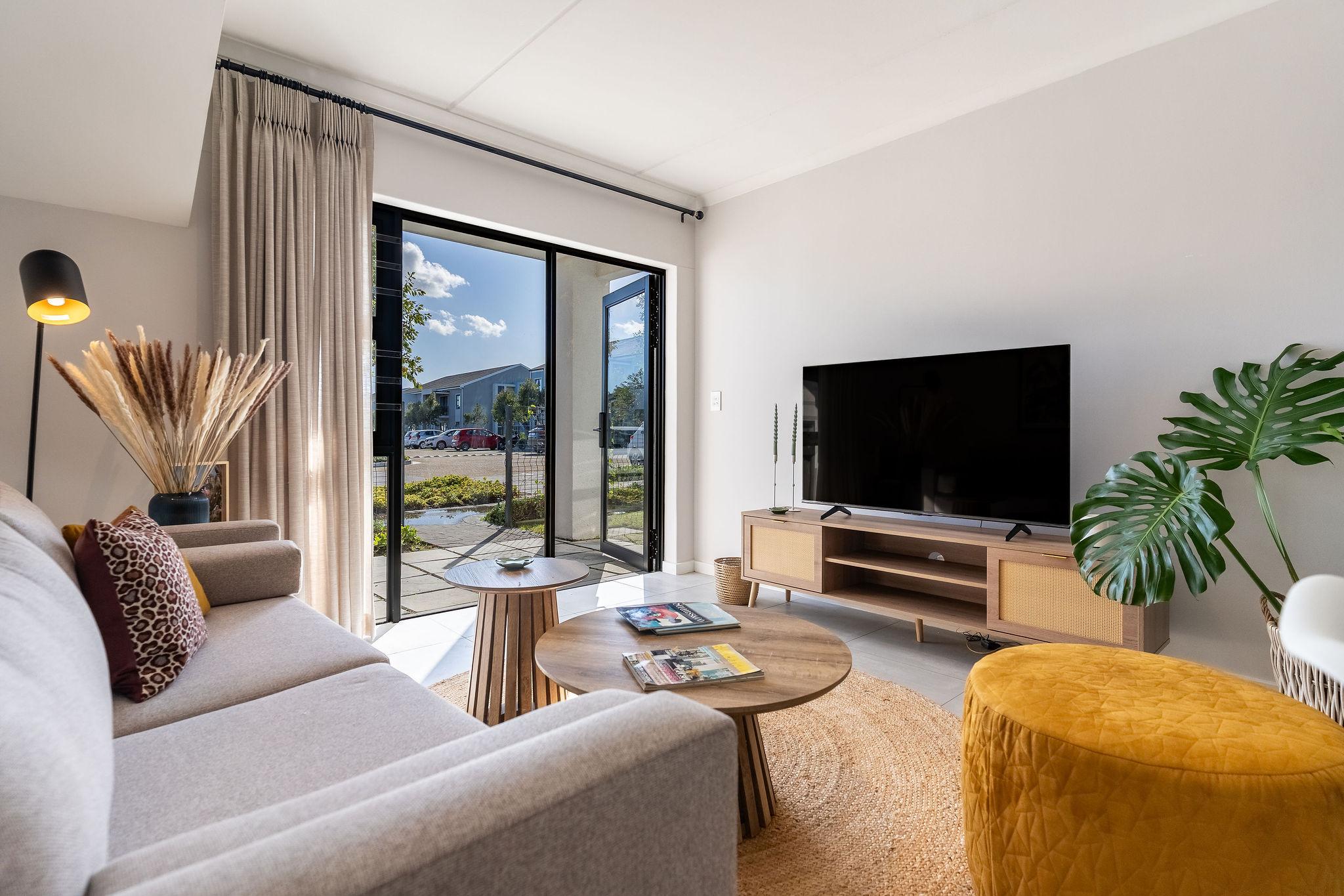 Cape Vine living room with reading lamp and smart TV console