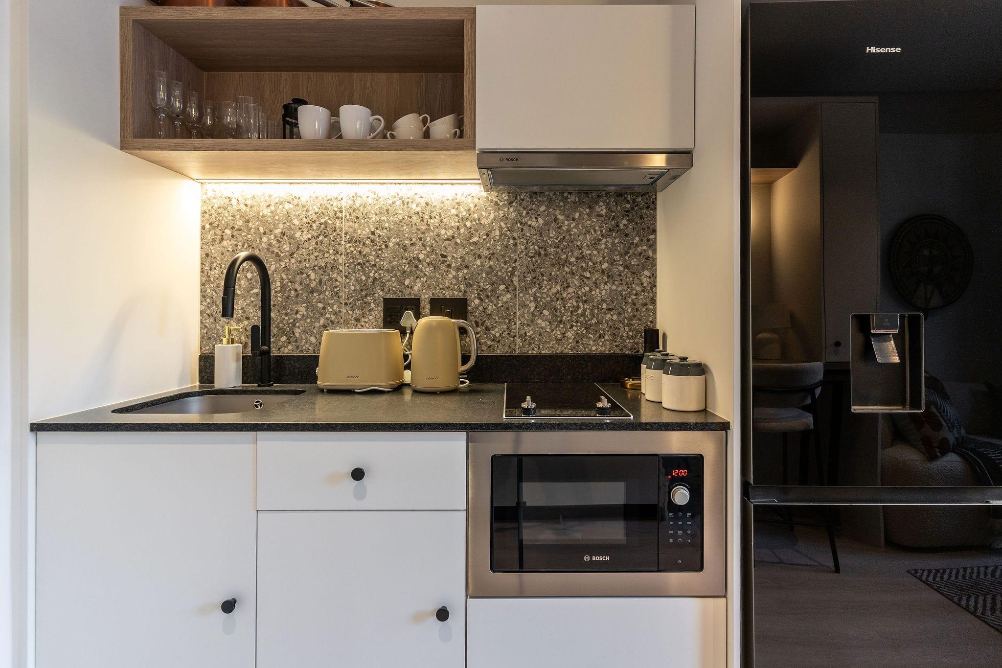 Centrepark kitchenette with terrazzo splashback and gas hob