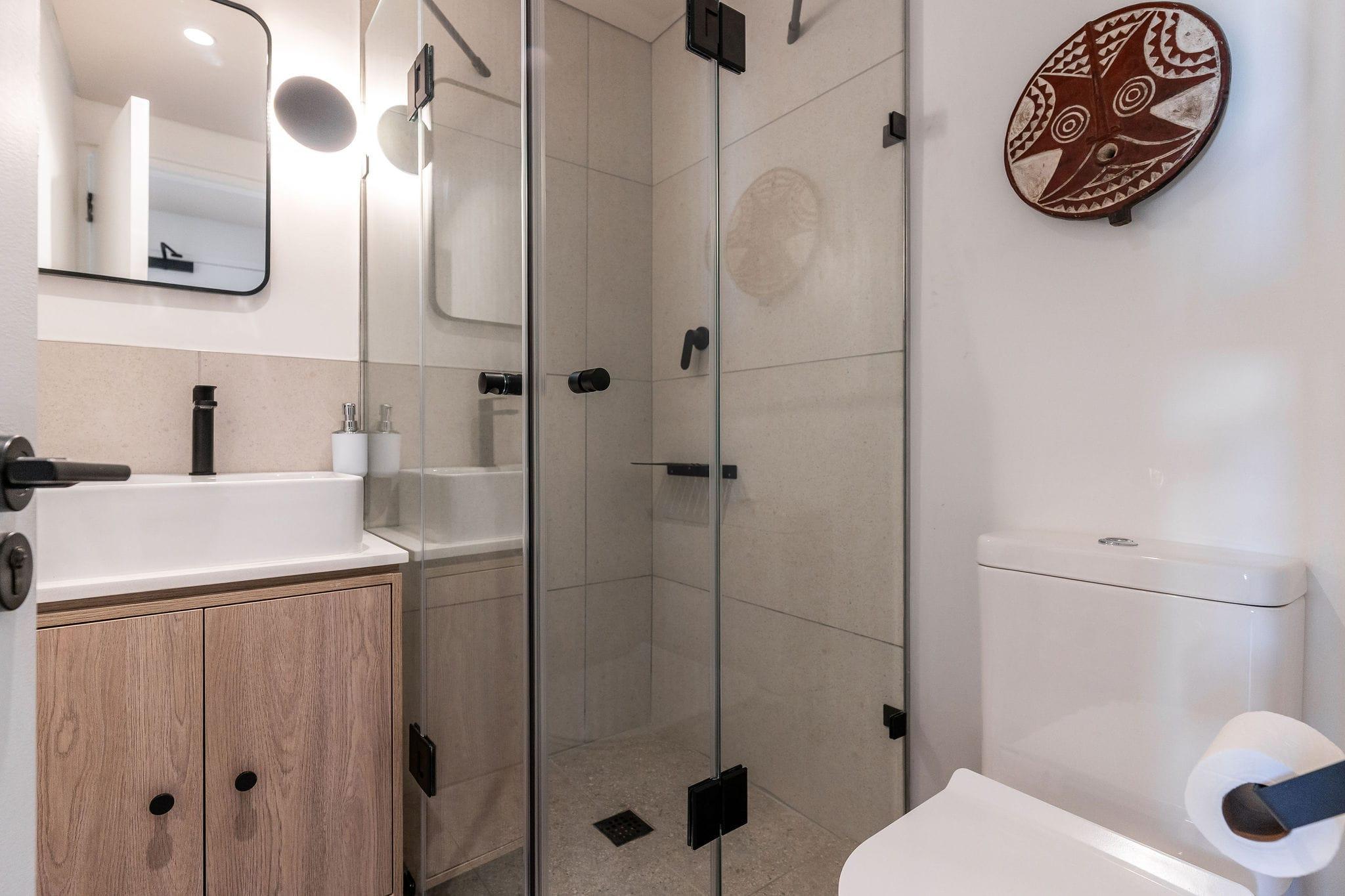 Mountainview bathroom with a black-framed mirror and glass-enclosed shower