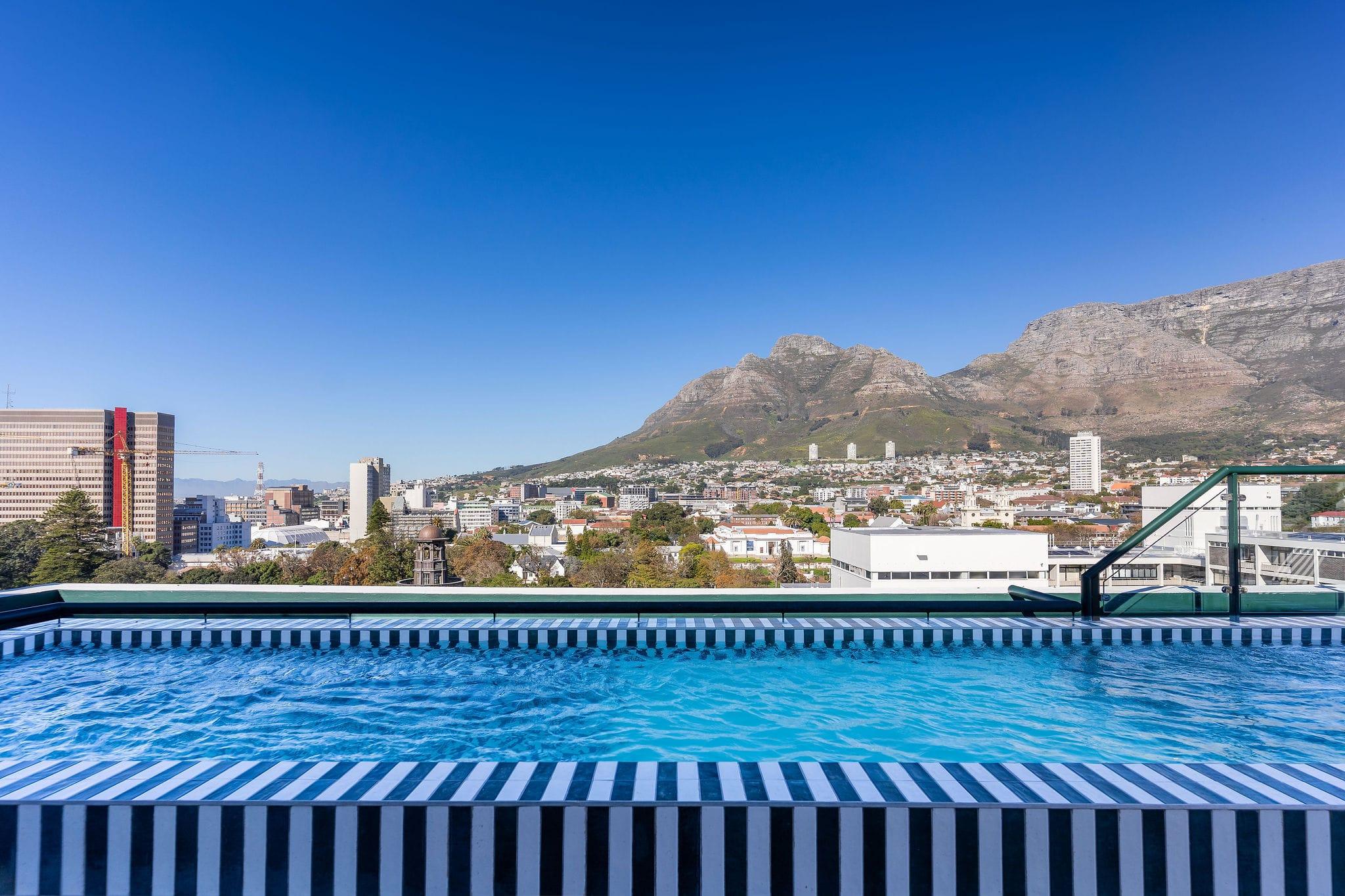 Ten on V rooftop pool corner with Table Mountain rising above the city